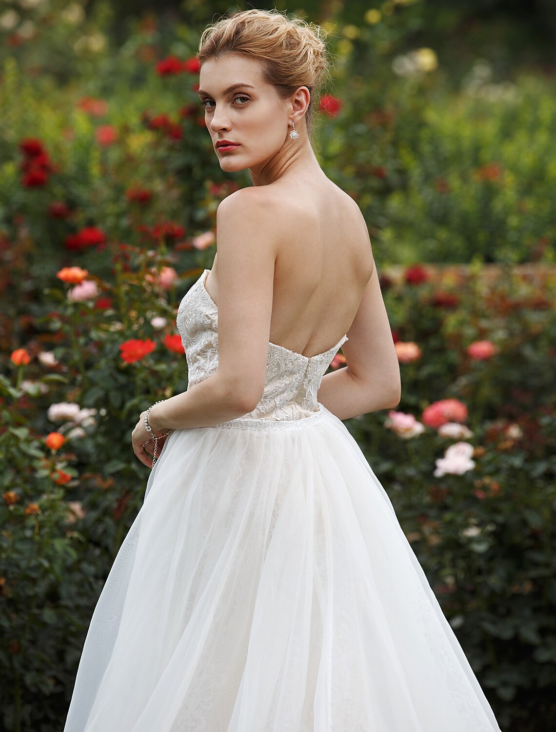 Bride posing gracefully in the mermaid wedding dress, showing the flow of the court train.