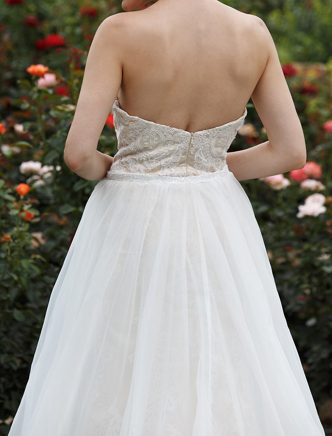 Another angle of the mermaid wedding dress, featuring its delicate lace appliques and overall design.