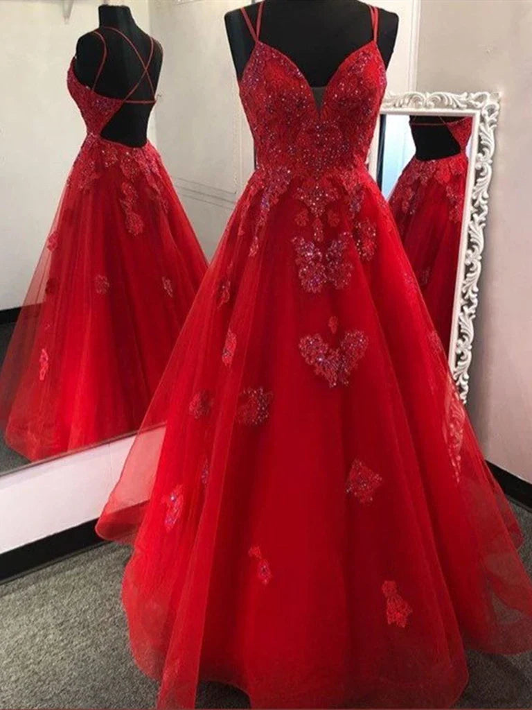 Woman wearing a long V-neck backless A-line gown with tulle and lace details.