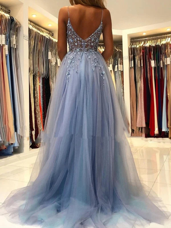 Side profile of a model wearing the long beaded formal dress.