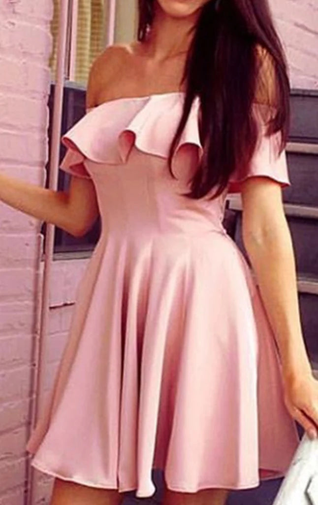 Close-up of the fabric and off-shoulder detail on the short dress.