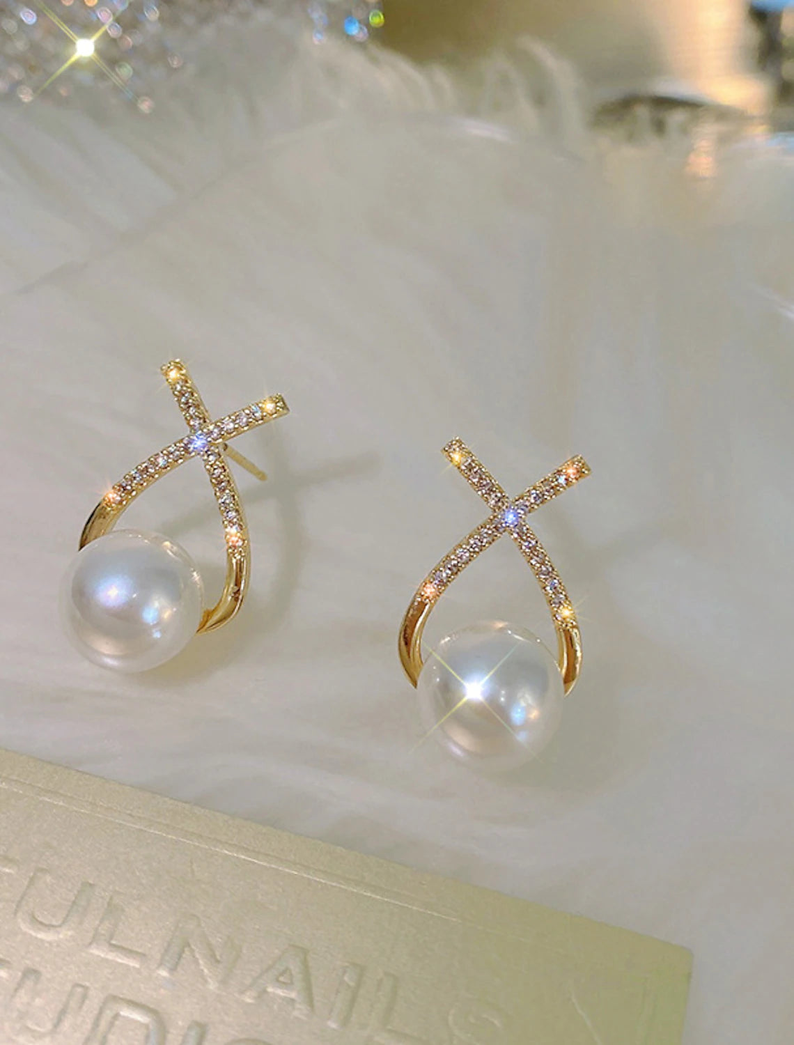 Gold floral earring displayed against a clean background.