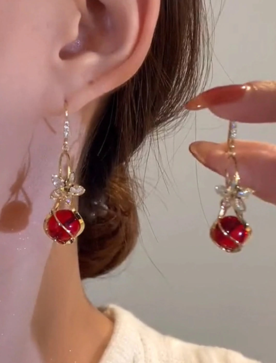 Close-up of a single petal opal drop earring.