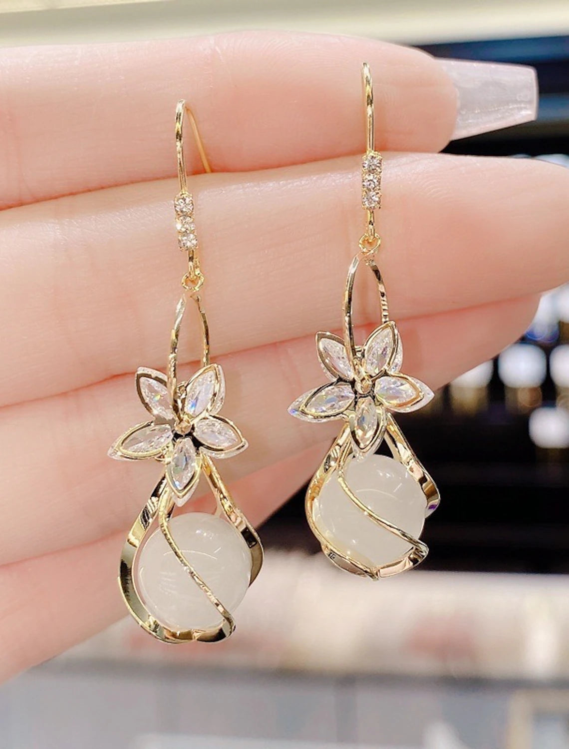 Pair of elegant petal opal drop earrings.