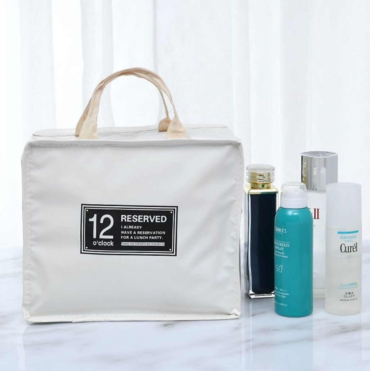 Portable travel cosmetic bag with zipper detail.