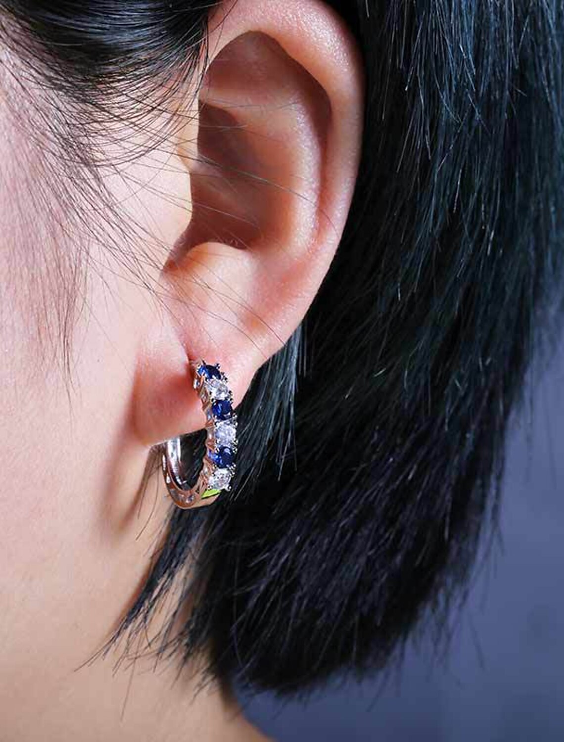 Zircon hoop earring in purple.