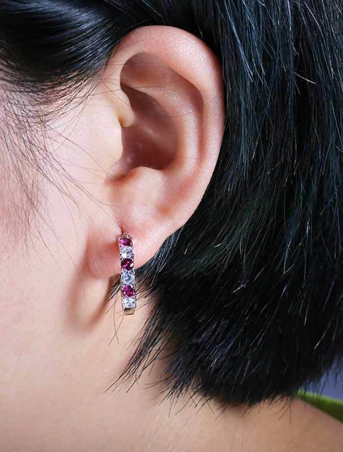 Close-up of a sparkling zircon hoop earring.