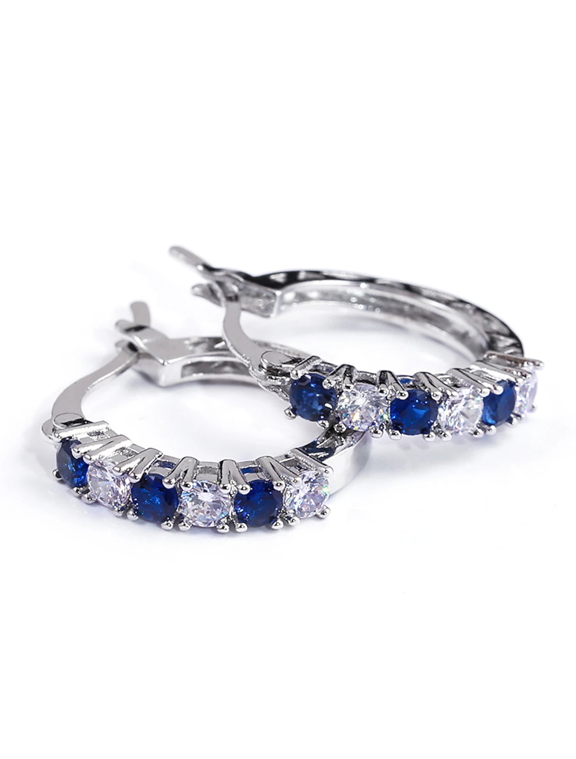 Model wearing blue zircon hoop earrings.