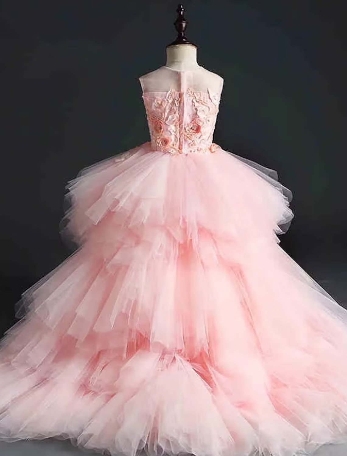 Back view of a pink sleeveless knee-length dress for girls.