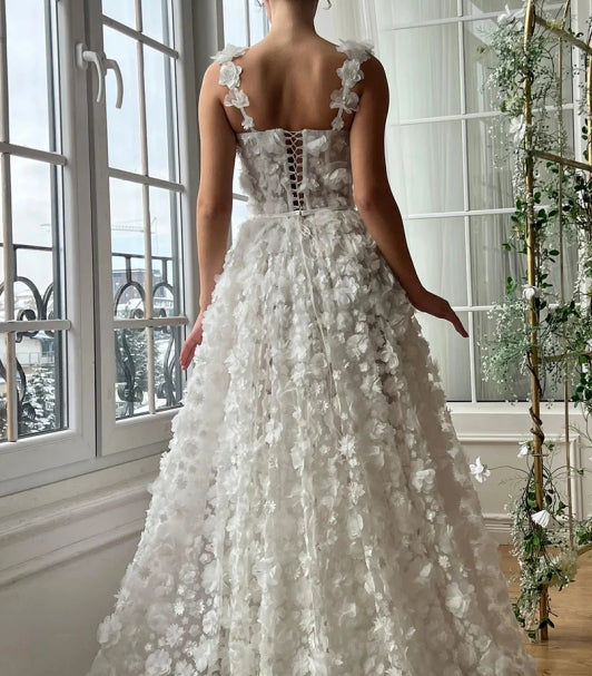 Close-up of floral embellishments and sweetheart neckline on a tulle prom dress.