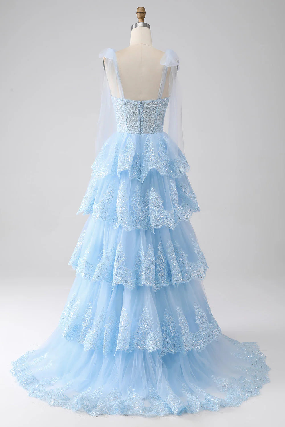 Close-up of sequin appliques on sweetheart neckline prom dress.