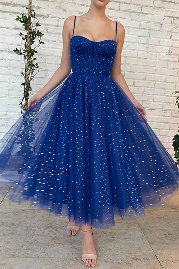 Side view of a woman modeling a tea length sweetheart strap dress.