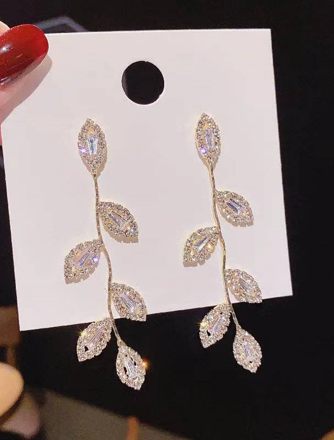 Detailed view of the S925 sterling silver geometrical leaf design on the drop earring.