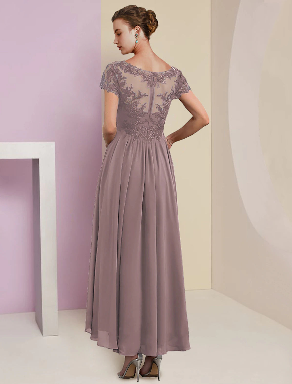 Woman posing in a two-piece formal dress, holding the matching wrap.