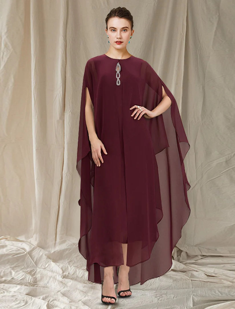 Woman wearing an elegant two-piece sheath Mother of the Bride dress with jewel neck, tea length chiffon skirt, and beaded.