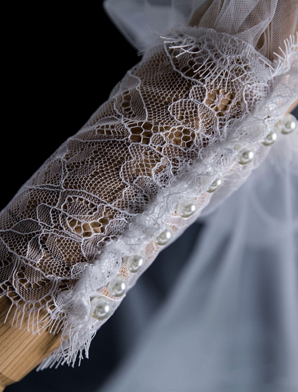 Bride wearing a two-tier cathedral wedding veil with faux pearls.