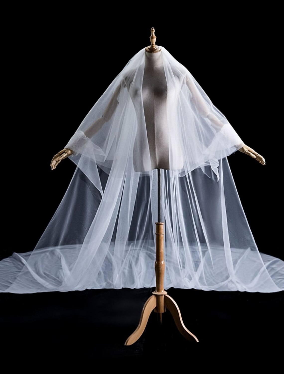 Bride showcasing the two-tier design of a pearl wedding veil.