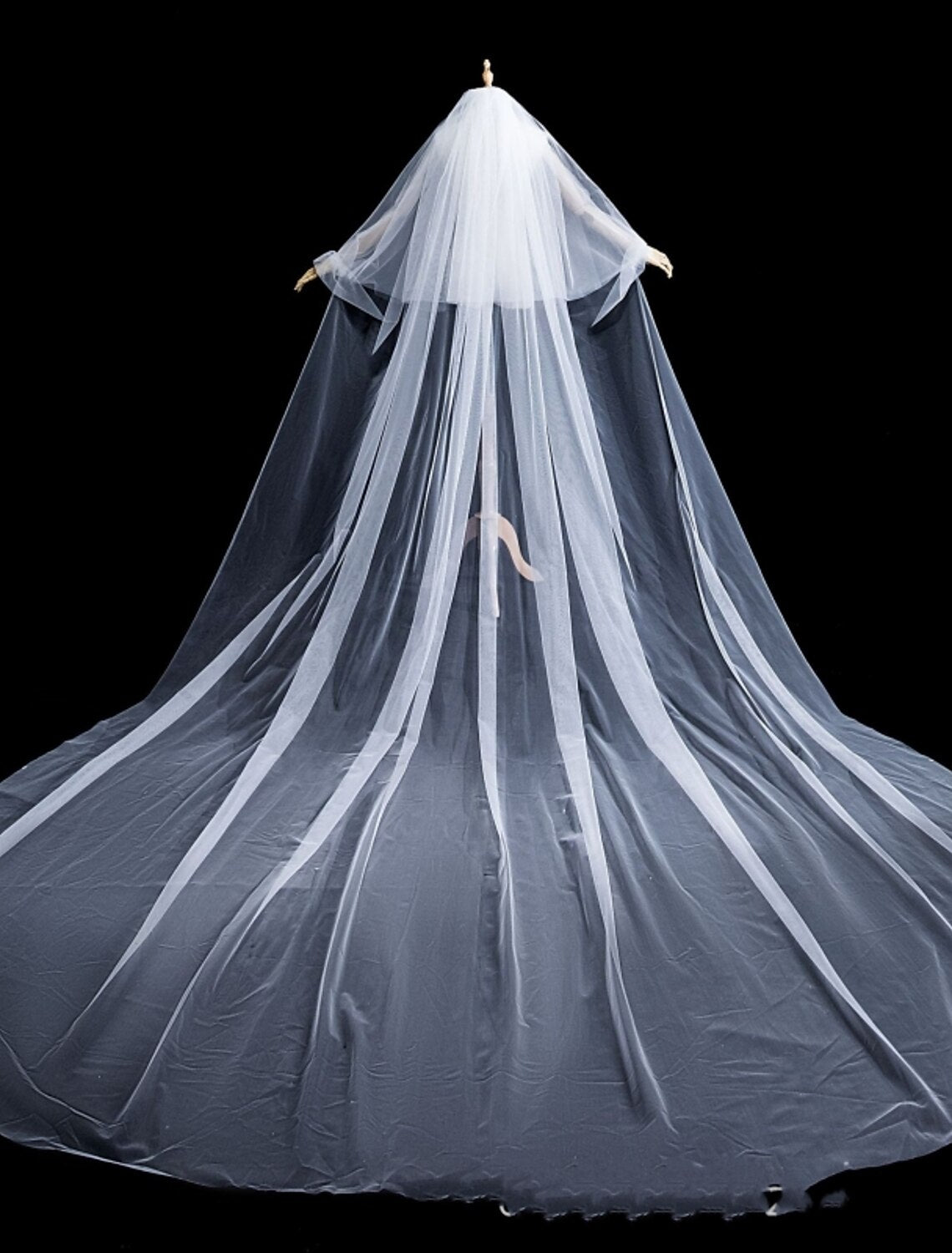 Detailed view of the delicate faux pearls on tulle fabric.