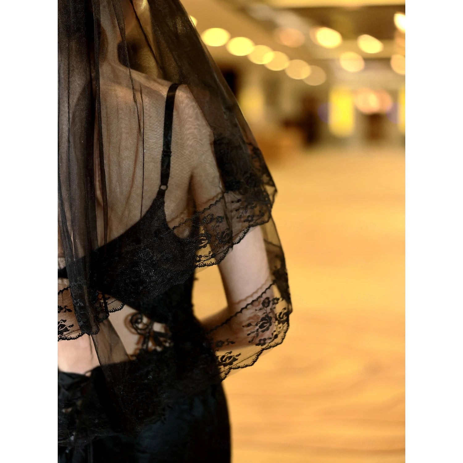 Side profile of a wedding veil showing its two-tier design.