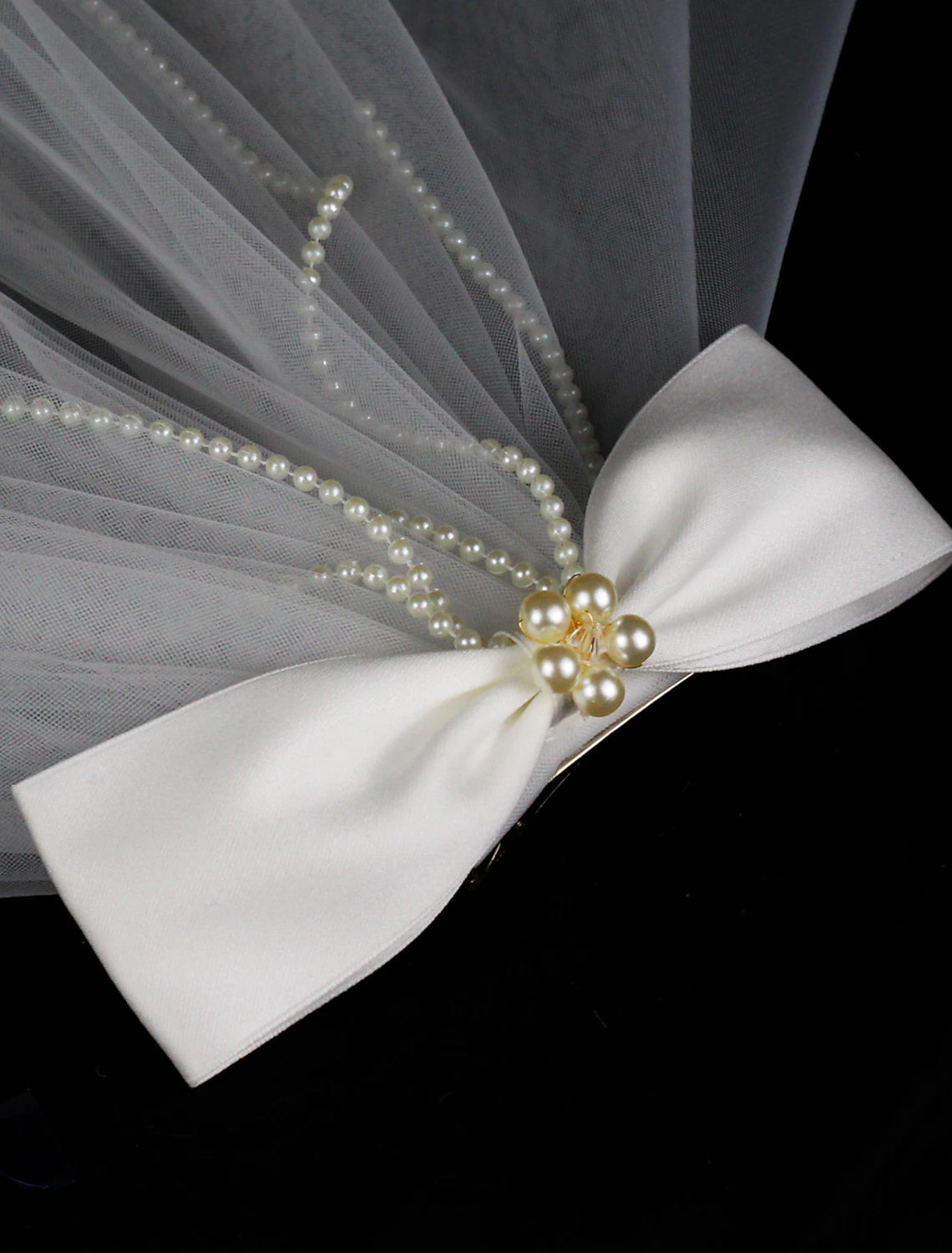 Bride wearing the two-tier elbow wedding veil, viewed from the side.
