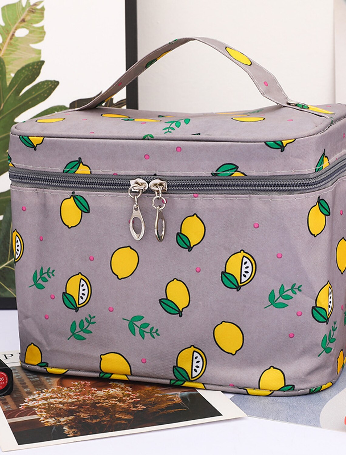 Side view of pink cherry polyester cosmetic bag.