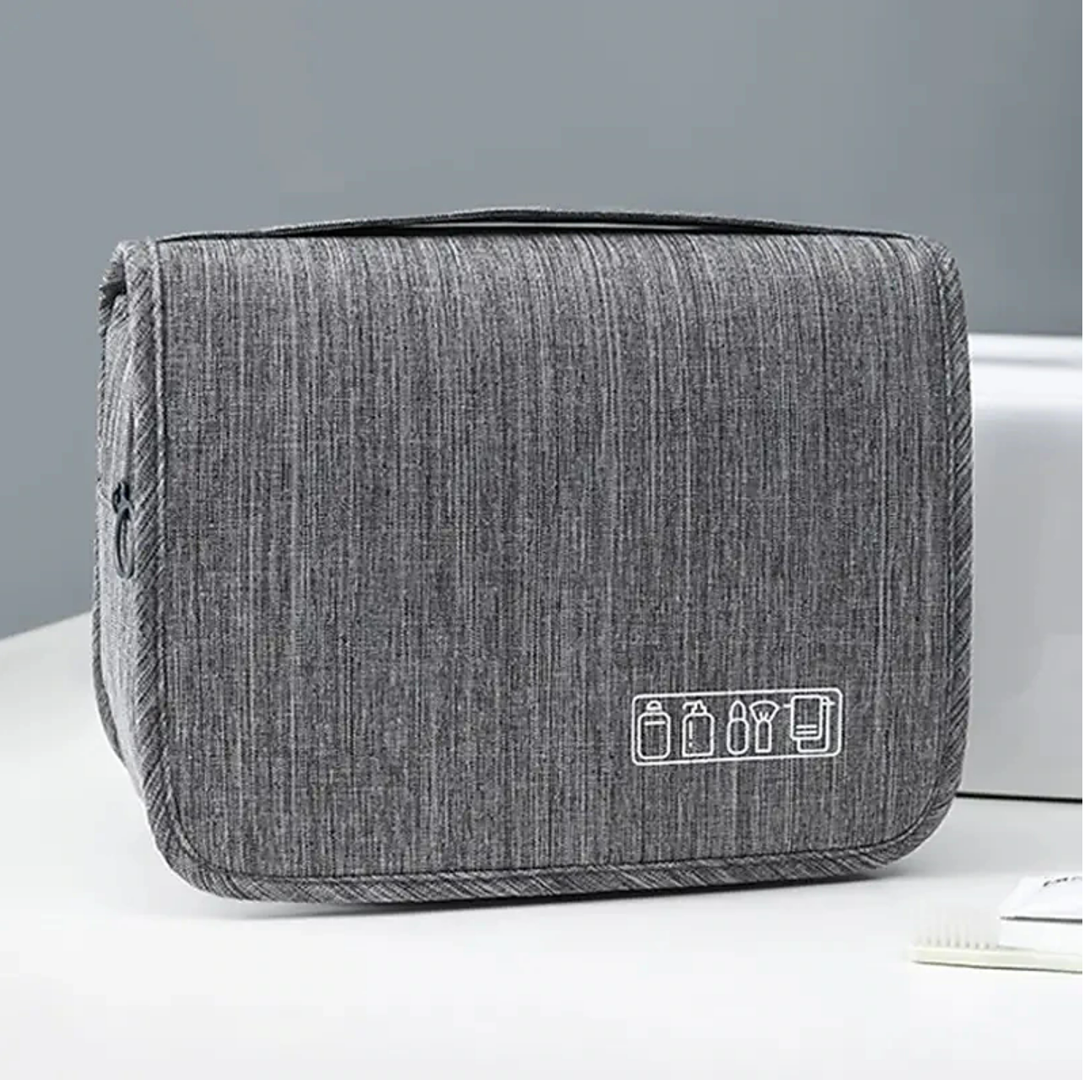 Close-up of the hanging hook and top handle of the travel toiletry bag.