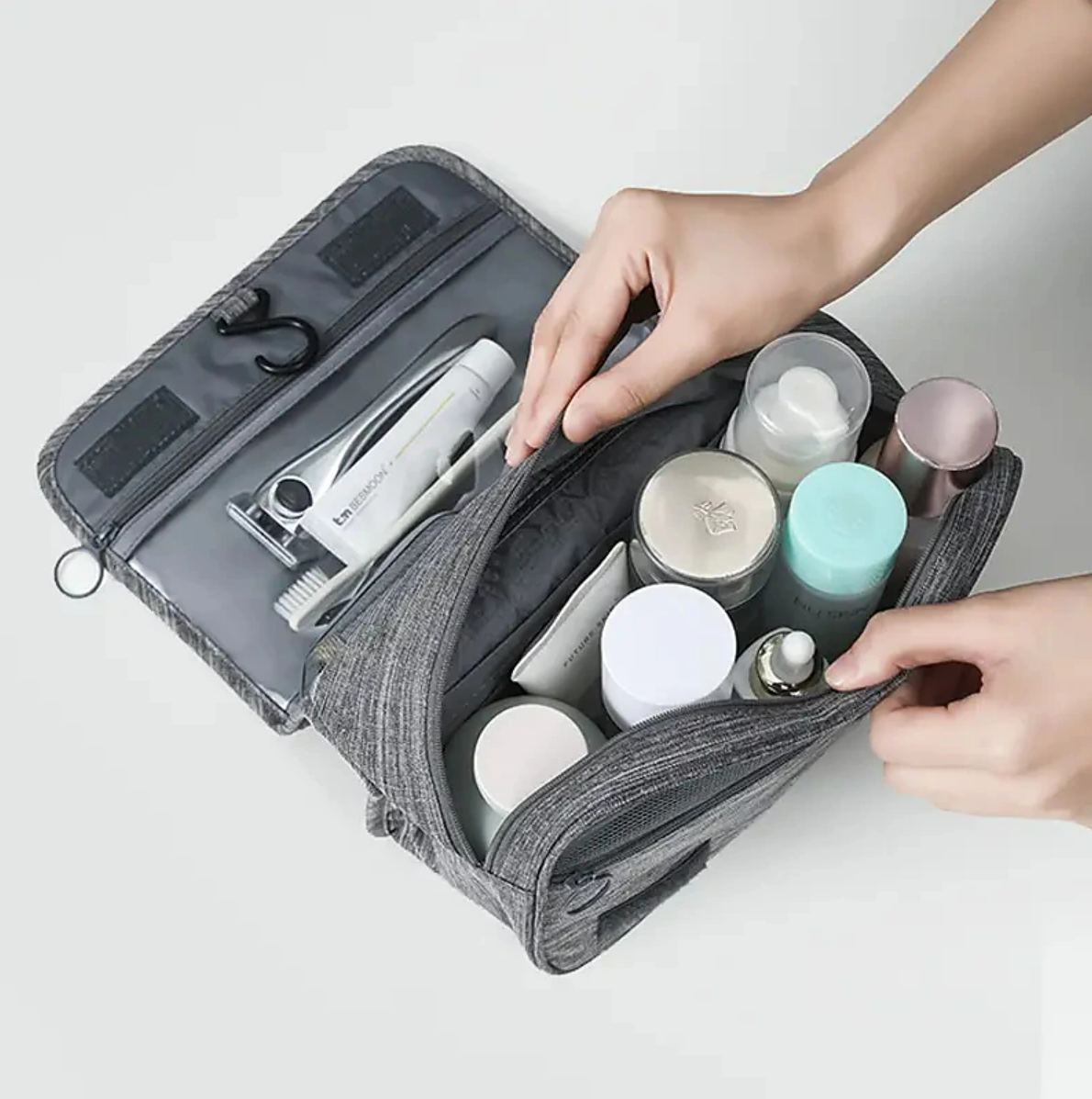 Hanging travel bag with a clear zippered pocket for easy visibility of contents.