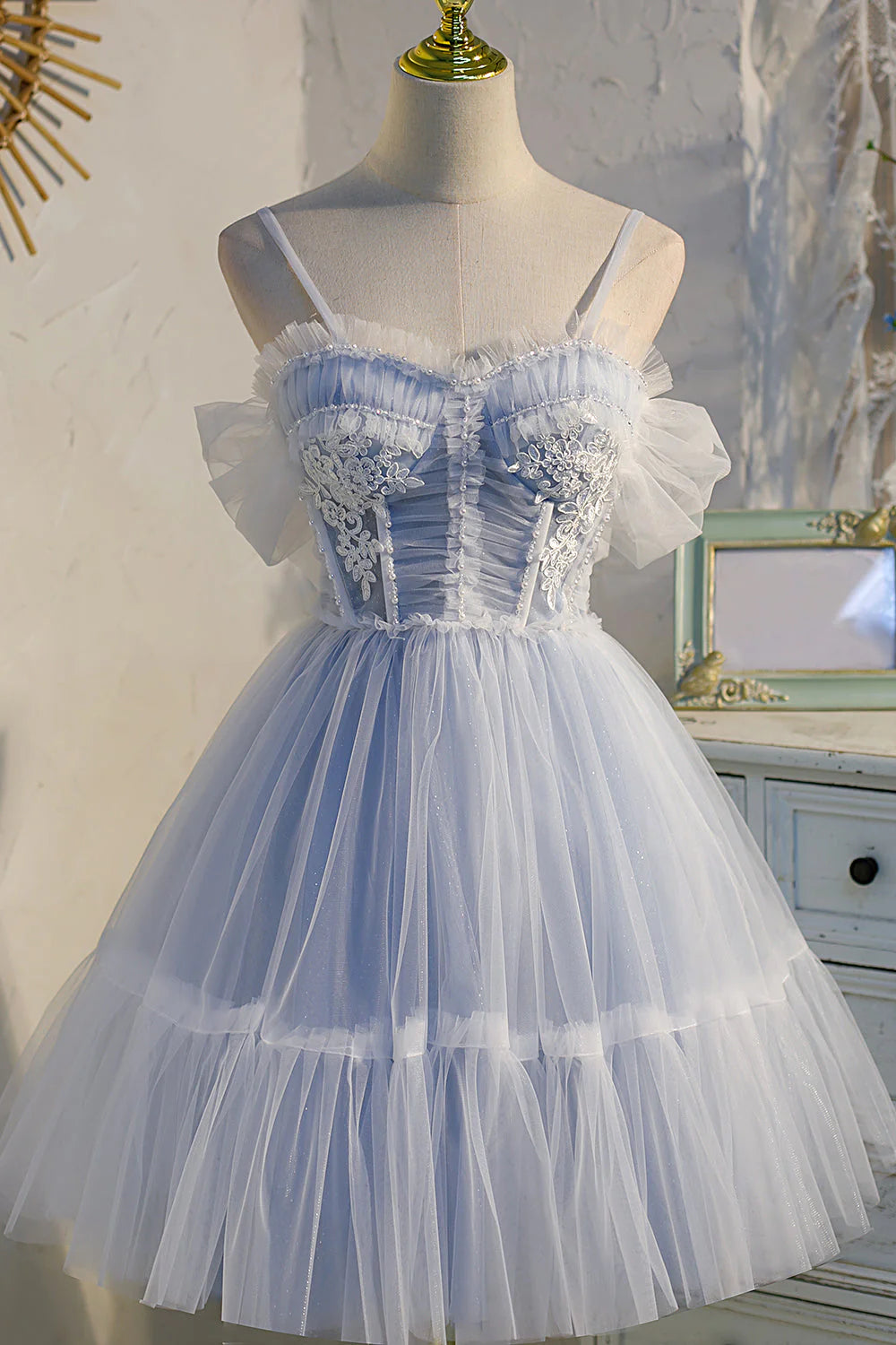 Model wearing a vibrant pink short tulle prom dress with lace appliques and a sweetheart neckline.
