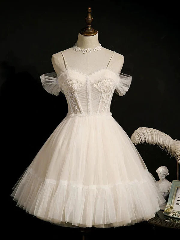 Close-up of the lace appliques and tulle fabric on a short prom dress.
