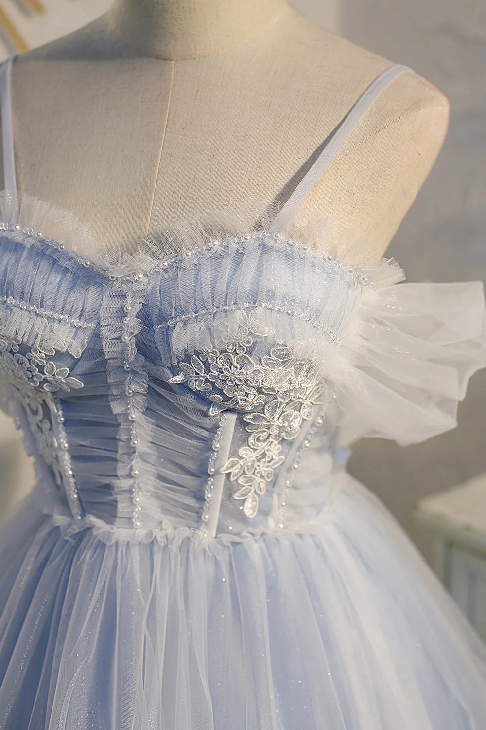 Full view of a short purple tulle prom dress with delicate lace details.