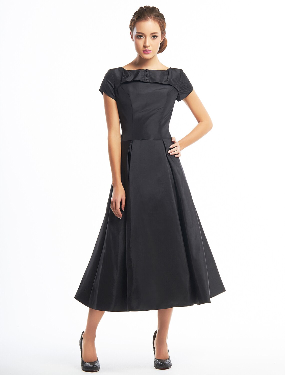 Model wearing a vintage A-line black taffeta dress with boat neck and short sleeves.