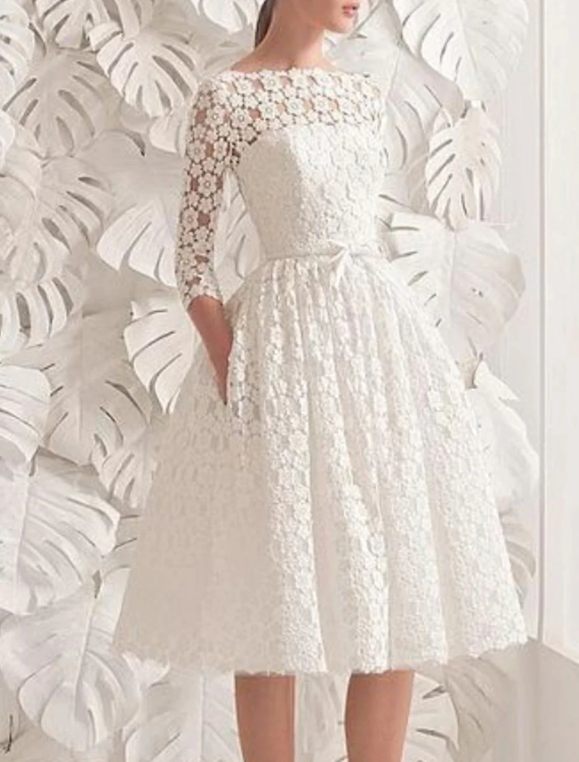 Close-up of illusion neck and 3/4 sleeves on vintage wedding dress.