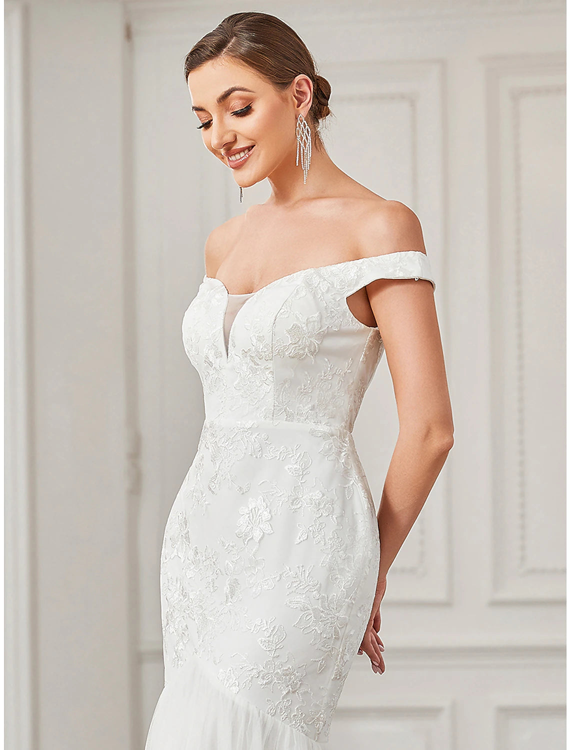 Close-up of the intricate lace appliques on the vintage wedding dress.
