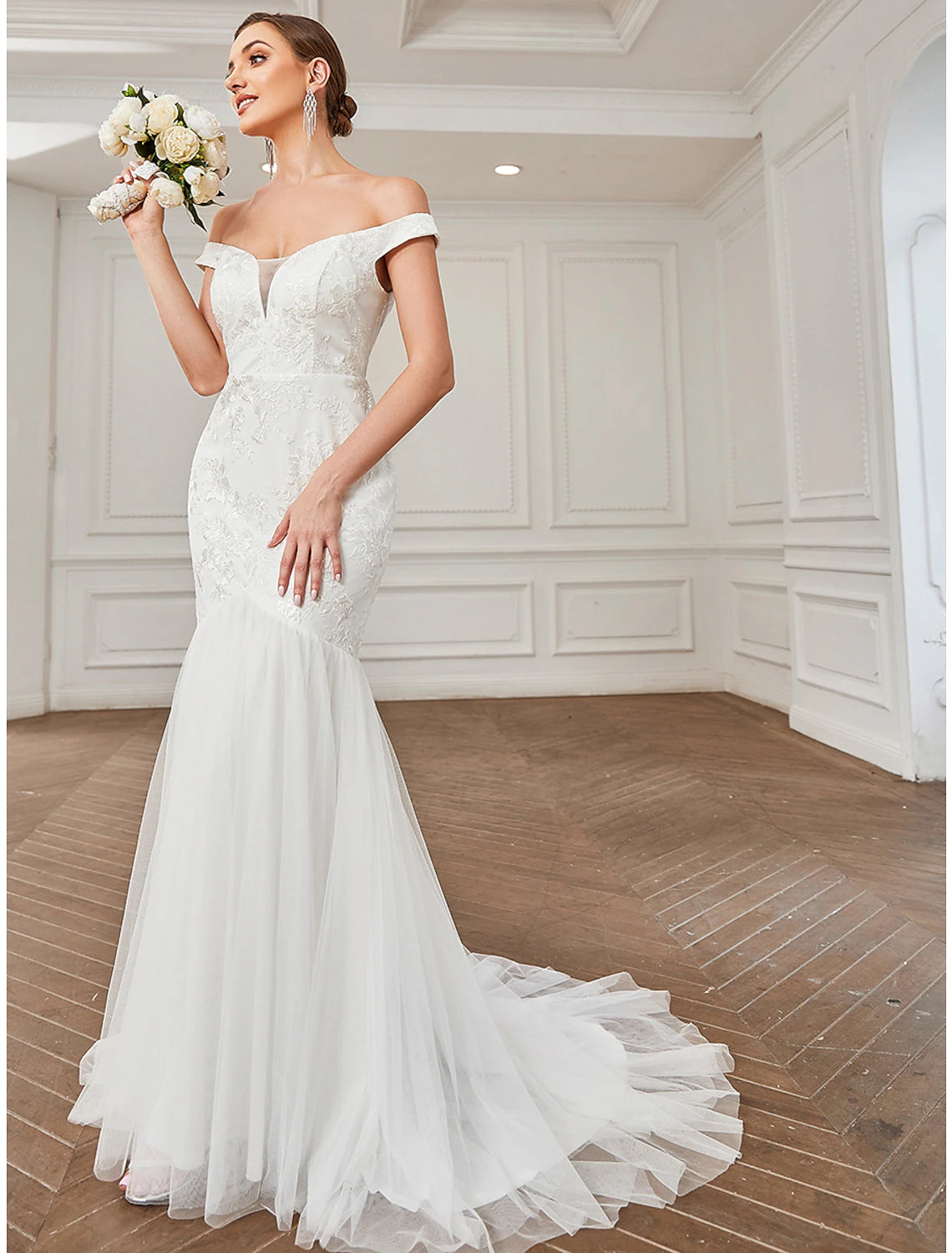 Side profile of the bride in the vintage off-shoulder lace gown.