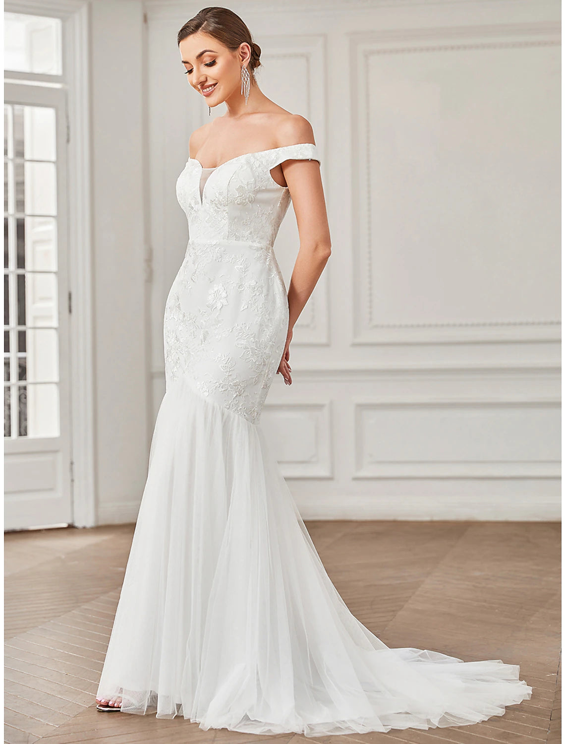 Full length view of the elegant A-line cap sleeve wedding dress.