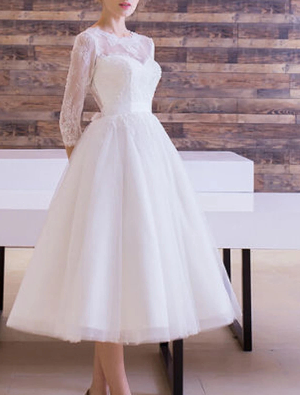 Vintage A-Line bridal gown with scoop neck and half sleeves, side view on model.