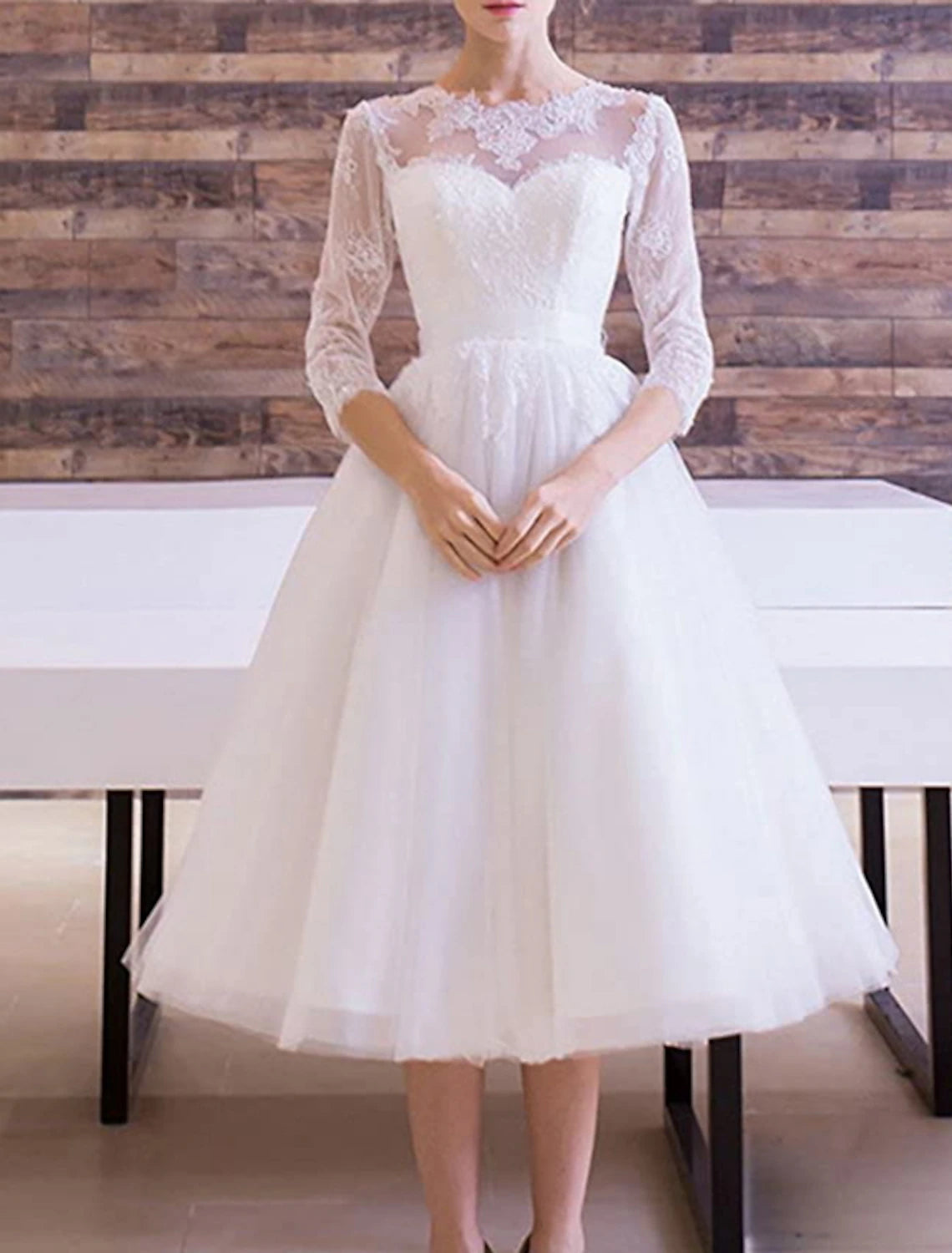 Vintage A-Line bridal gown with scoop neck and half sleeves, back view on model.