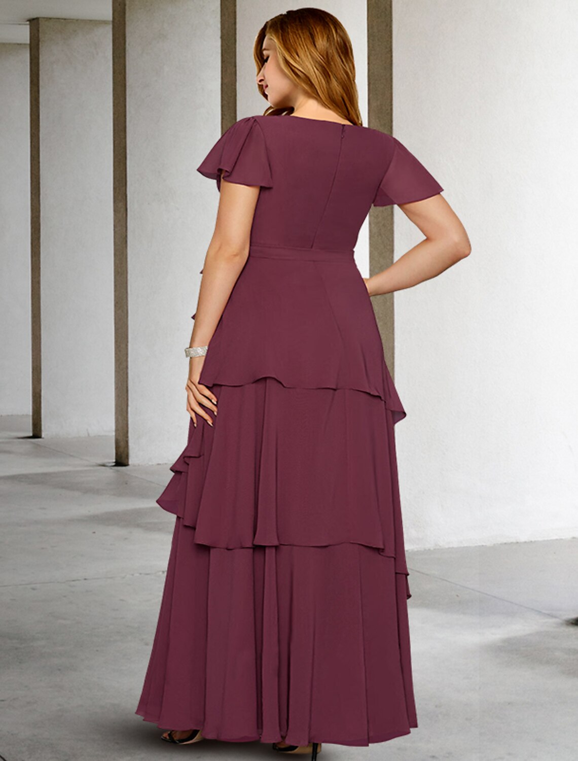 Back view of the formal floor-length chiffon gown with delicate ruffles.