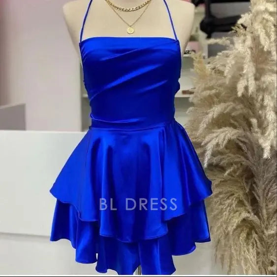 Woman wearing a royal blue A-line satin homecoming dress.