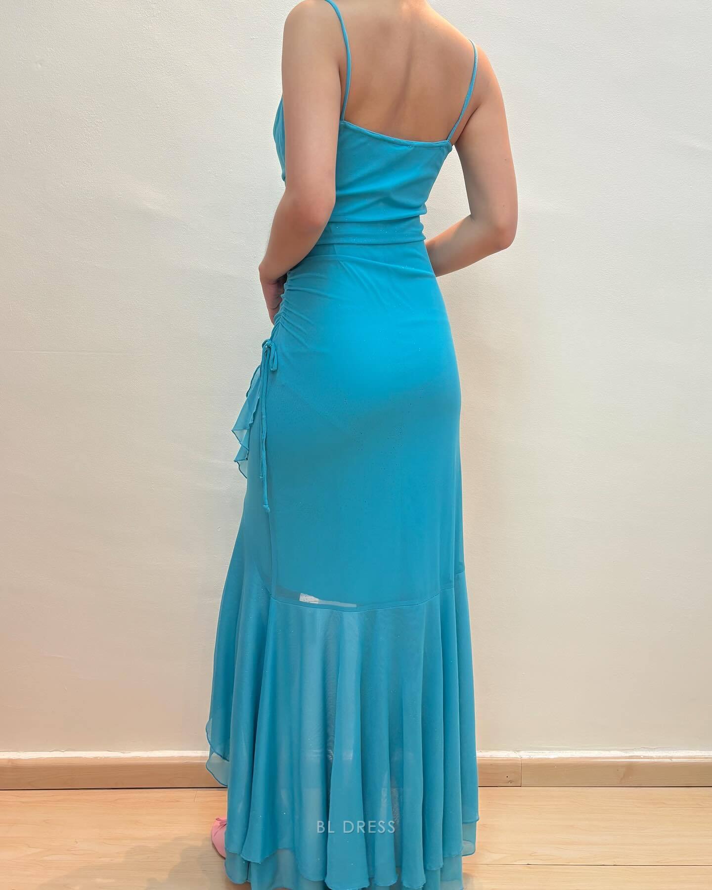 Back view of a vintage blue mermaid evening gown with delicate spaghetti straps.