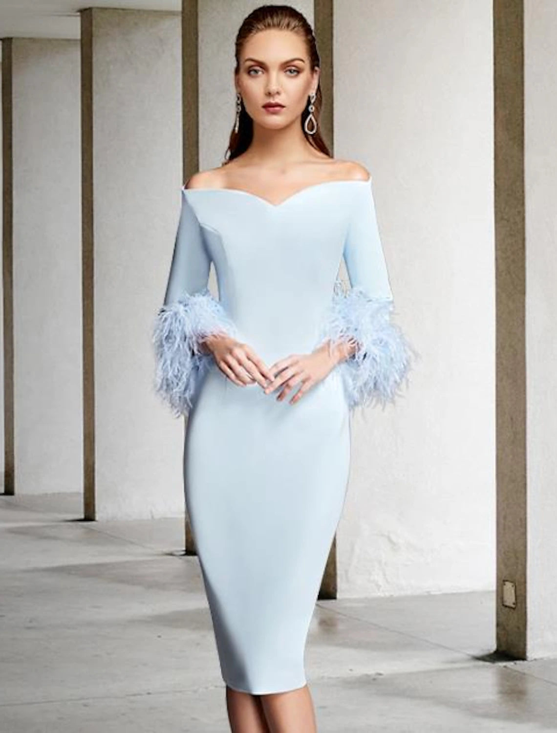Side view of vintage knee-length chiffon dress with feather detail.