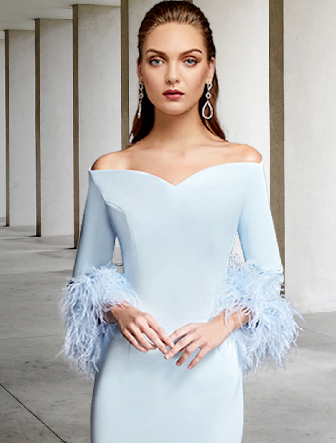 Close-up of stretch chiffon fabric and feather embellishment on dress.