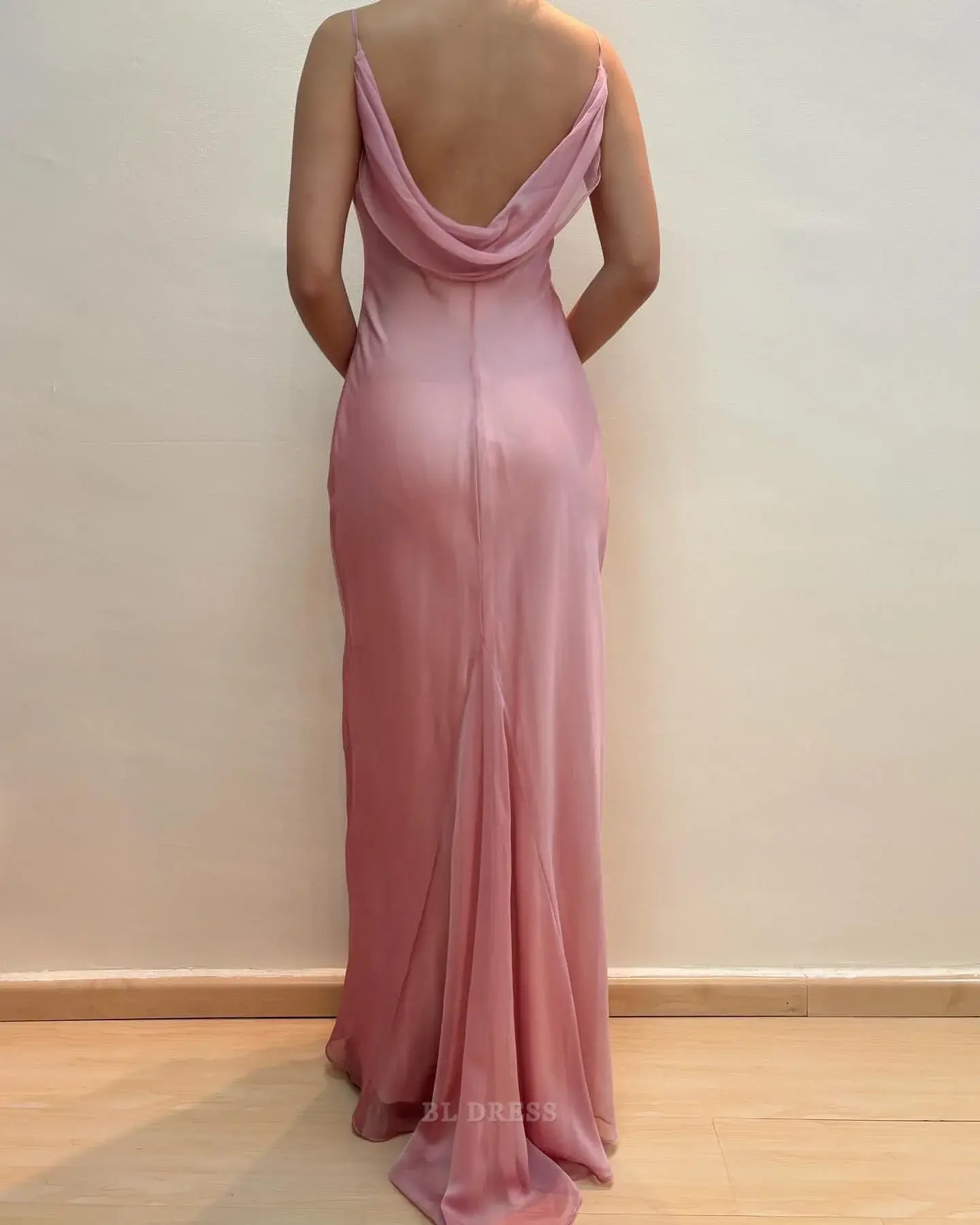 Elegant pink chiffon formal dress with spaghetti straps, side view.