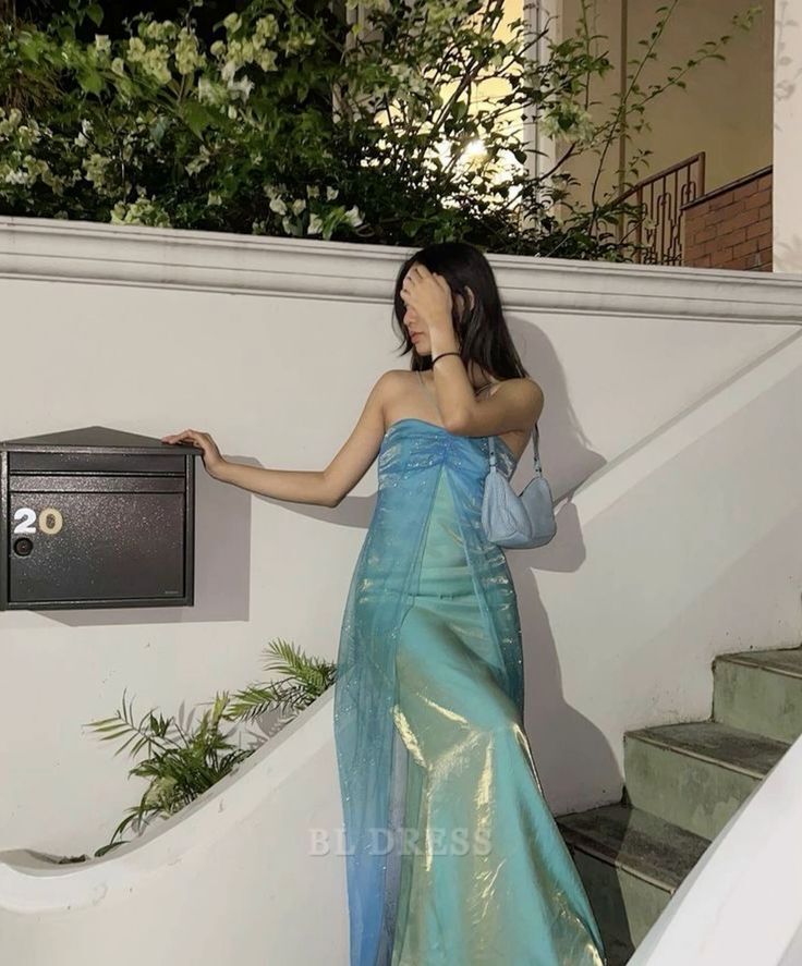 Woman wearing a vintage-style floor-length halter sheath dress.