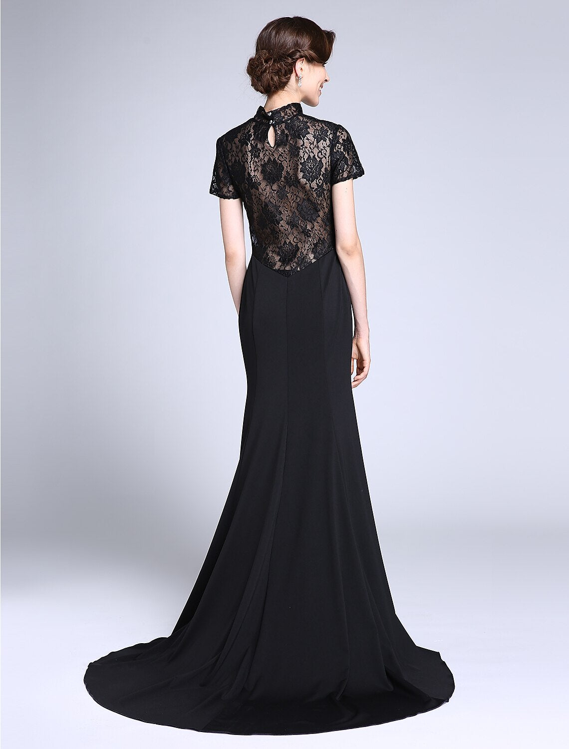 Side view of the high neck short sleeve lace gown with sweep train.