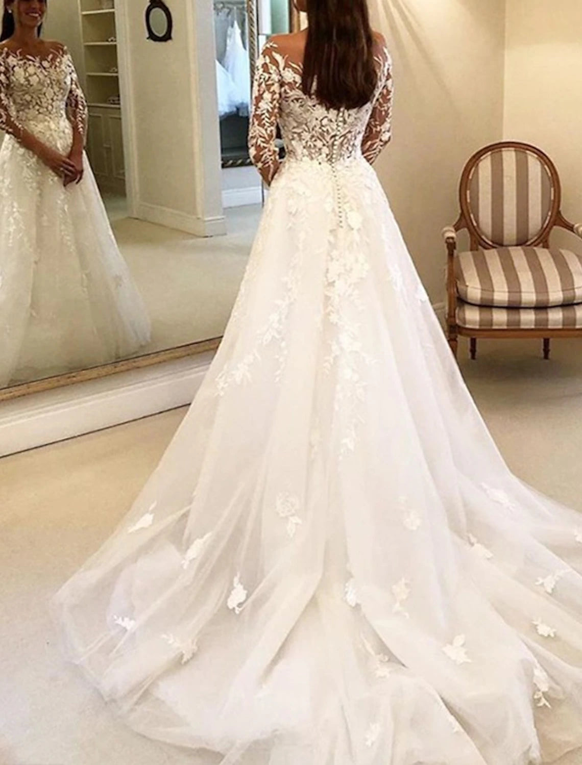 Back view of vintage lace wedding dress showing buttons and chapel train.