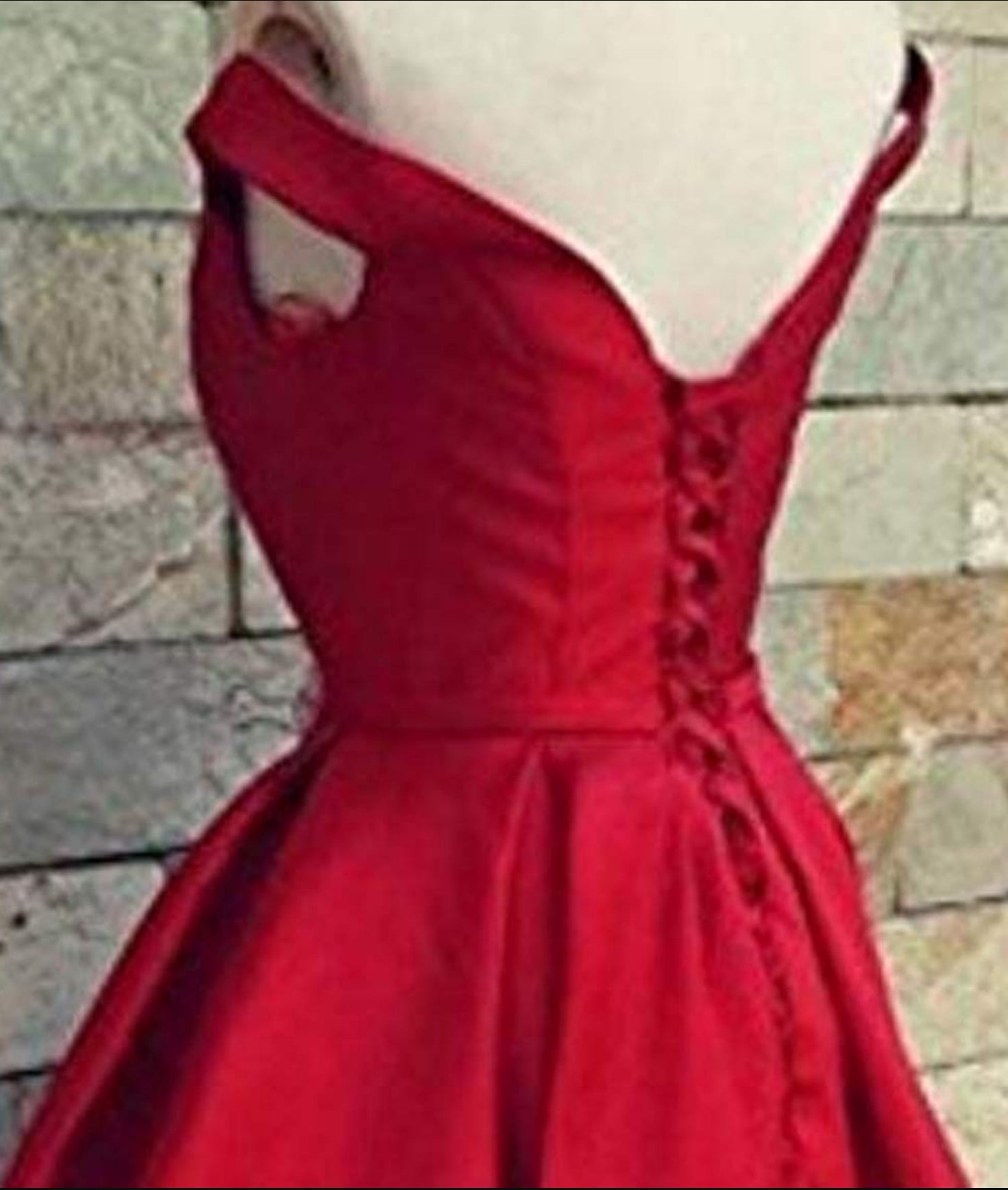 Luxurious satin ball gown featuring an off-shoulder neckline and pleated details.