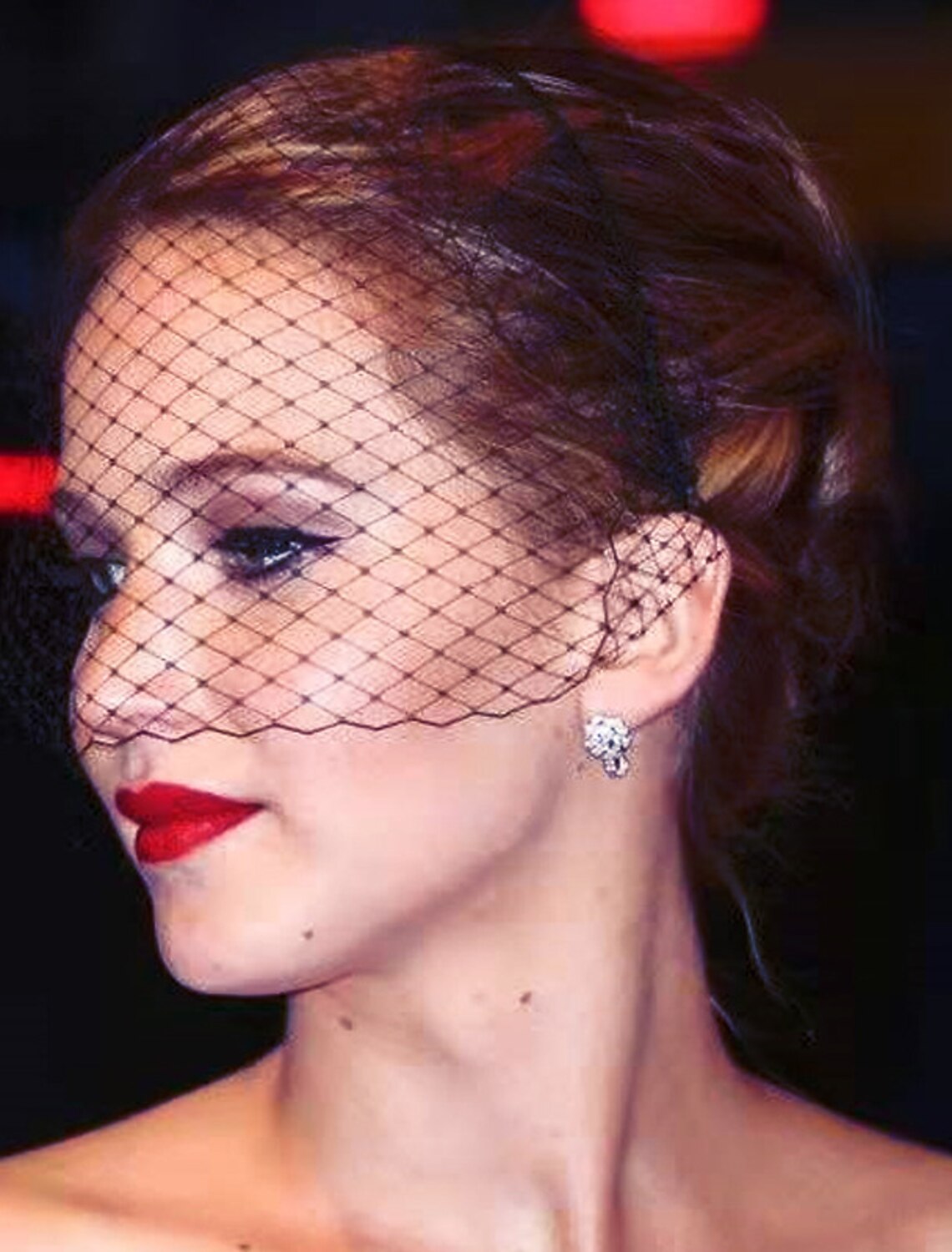 Close-up of a bride wearing a 40cm birdcage wedding veil with delicate tulle.