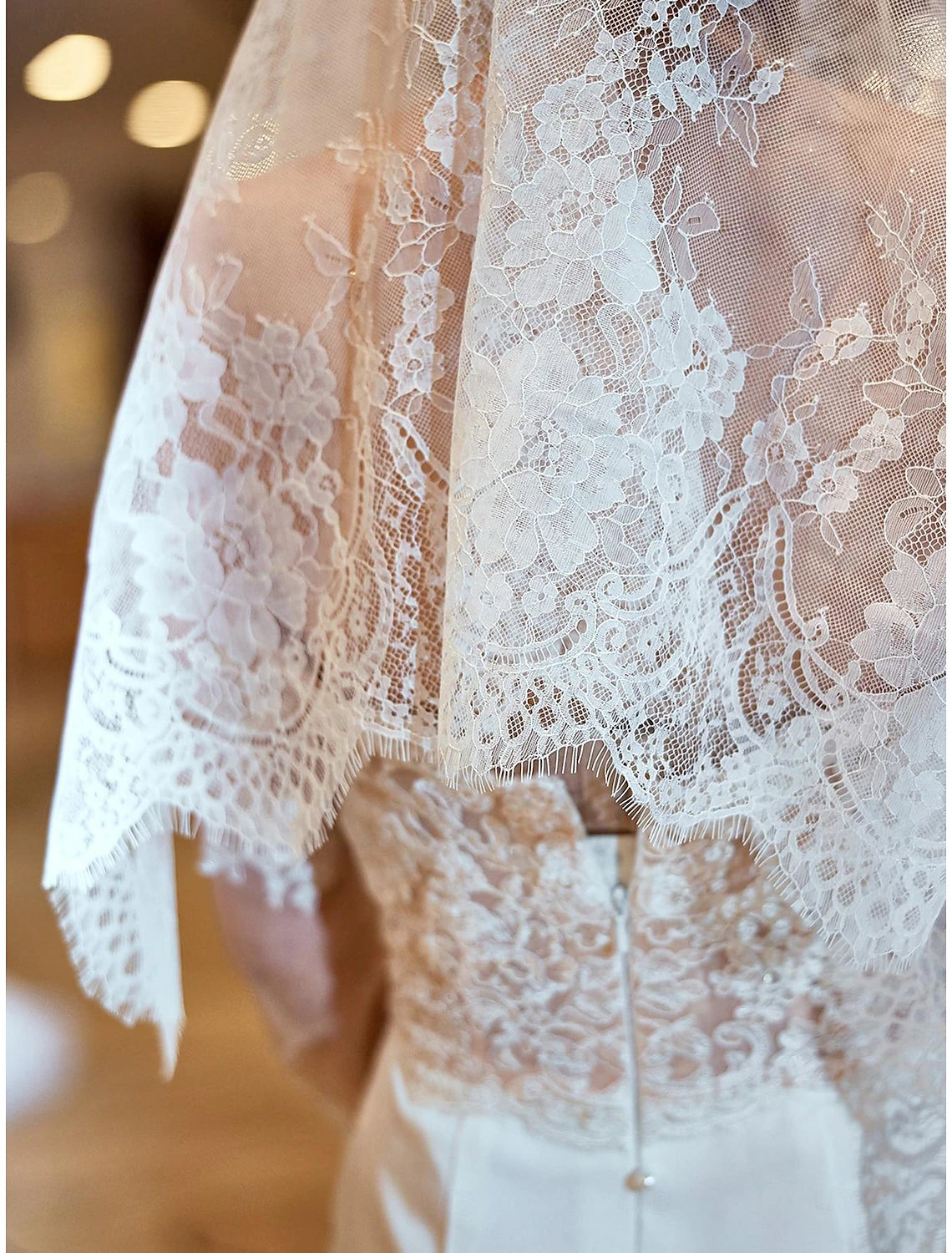 Bride wearing a one-tier vintage wedding veil with delicate embroidery and lace.