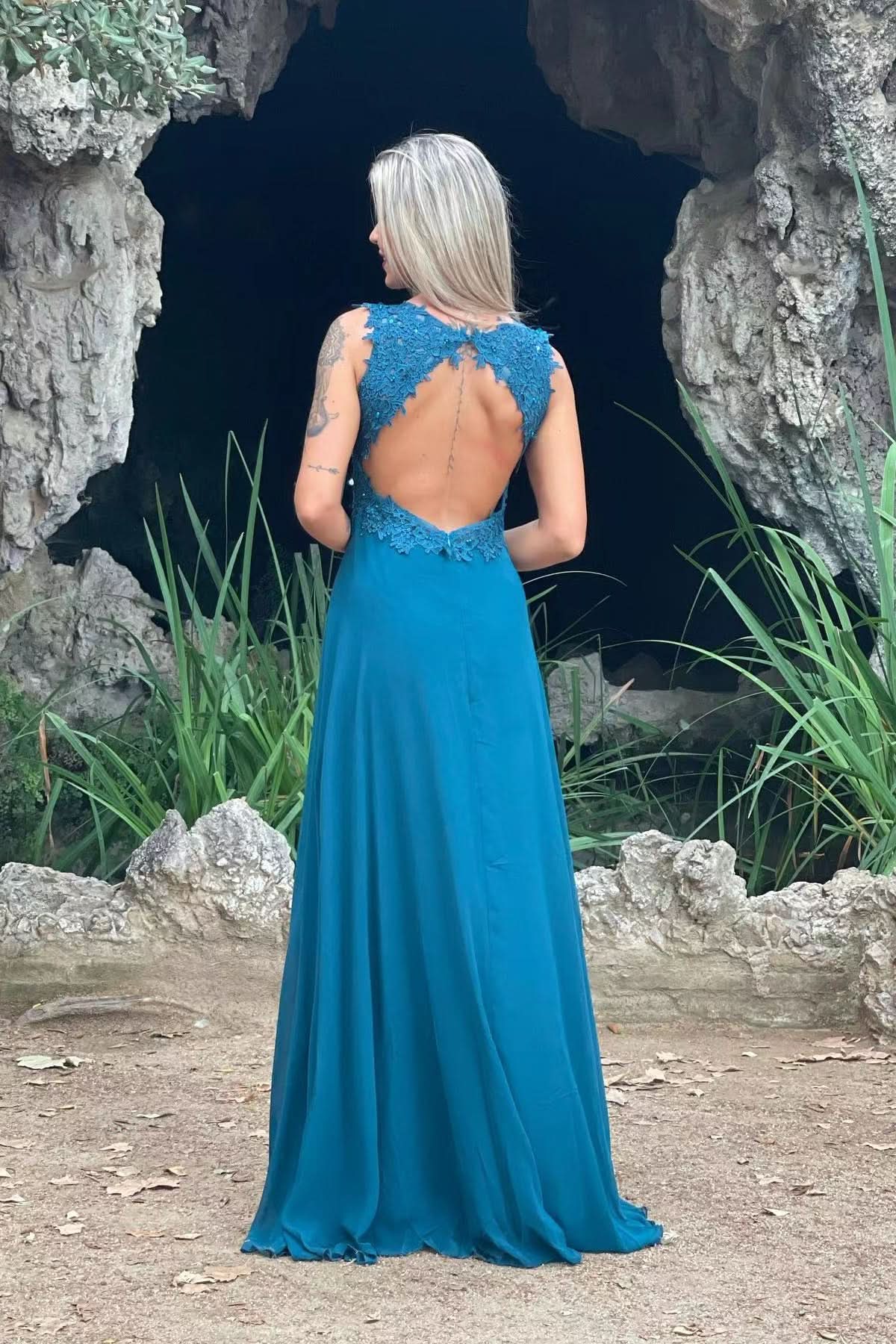 Side view of the red V-neck A-line prom dress, highlighting the split skirt.